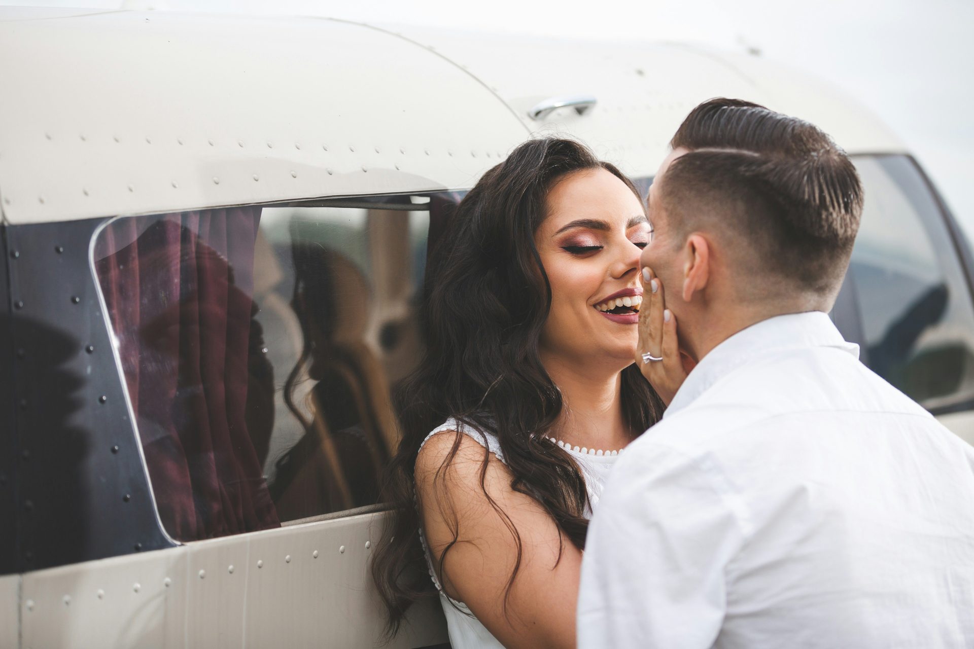 Couple embracing near a private airplane